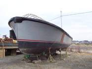 bow view open power launch before construction